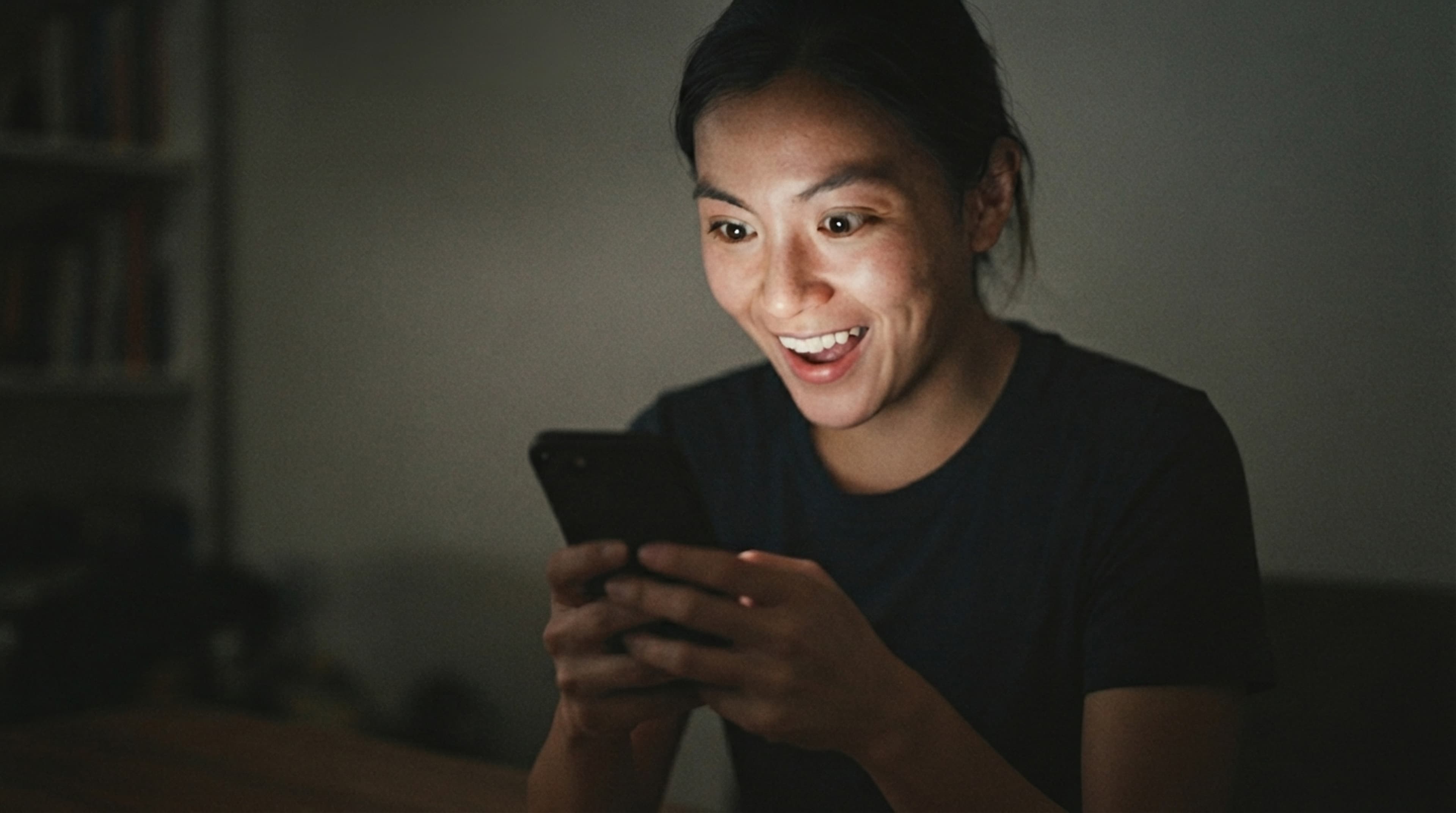 Someone smiling at their race photos on their phone
